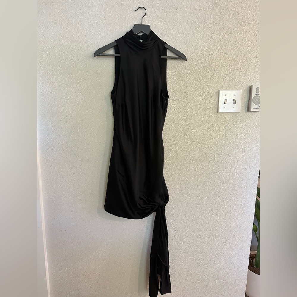 This black high-neck Cinq A Sept dress is great to wear was a wedding guest.